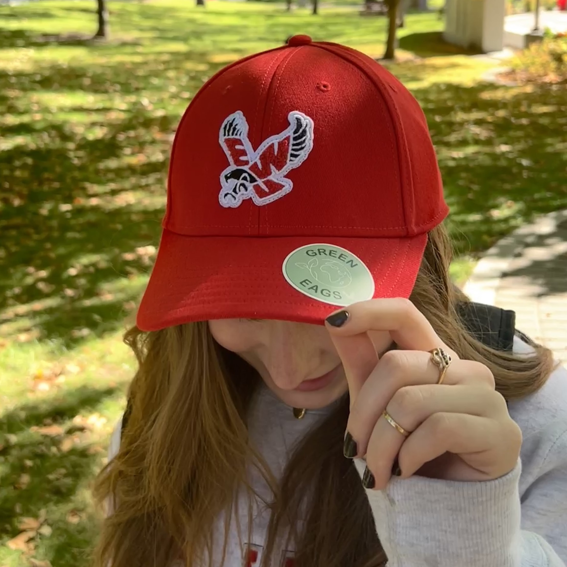 A student shows off the Green Eags sticker on her hat.